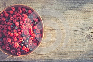 Fresh raspberries and blueberries in a bowl