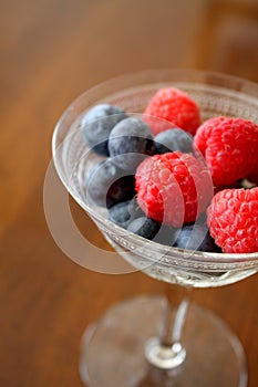 Fresh Raspberries and Blueberries in a Vintage Champagne Glass