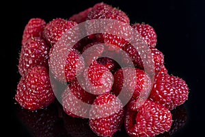 Fresh raspberries close up on a black background