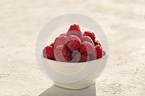 Fresh raspberries - tasty and healthy snack in the morning.Bowl of ripe fruit
