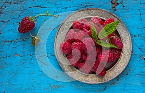 Delicious Fresh raspberries in vintage basket vitamins healthy food vegan ingredients. Selective focus