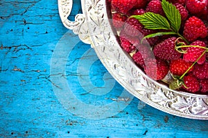 Delicious Fresh raspberries in vintage basket vitamins healthy food vegan ingredients. Selective focus