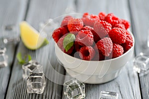 Fresh raspberries in a white bowl