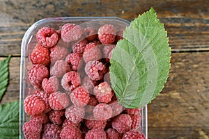 Fresh raspberries on a wooden background