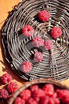 Fresh raspberry in a basket on wooden table