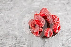 Fresh raspberry on the metal bucket