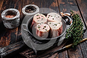 Fresh Raw beef Marrow bones in pan for cooking broth. Wooden background. Top view