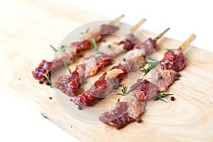 Fresh raw beef meat with rosemary and pepper isolated on white