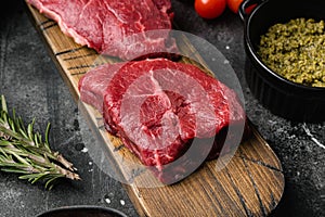 Fresh raw Beef meat Rump Steak, on black dark stone table background