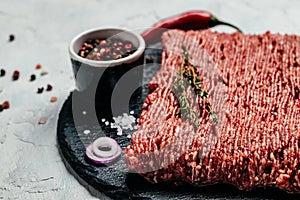 Fresh Raw Beef Minced Meat on a light background. Food recipe background. Close up. Long banner format. top view