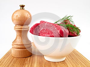 Fresh raw beef and pepper mill