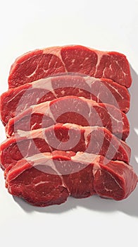 Fresh raw beef pieces arranged elegantly against pristine white background