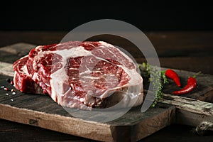 Fresh raw beef rib eye steak with red pepper