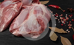 Fresh raw beef steak on black stone background