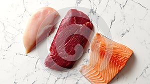 Fresh raw beef steak, chicken breast, and salmon fillet