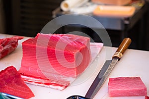 Fresh and raw big tuna fish was cut into pieces at the Tsukiji fish market, Japan..Fresh tuna