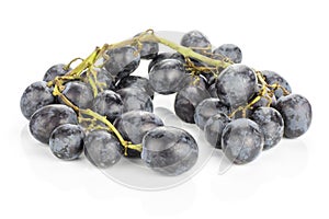 Fresh raw black grape isolated on white