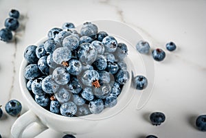 Fresh raw blueberry in white cup