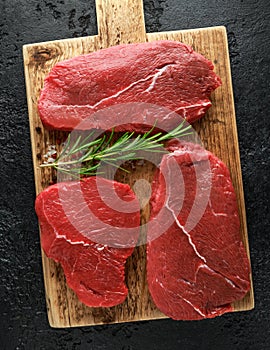 Fresh Raw braising beef steak on wooden board