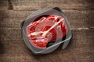 Fresh Raw braising steak on black tray