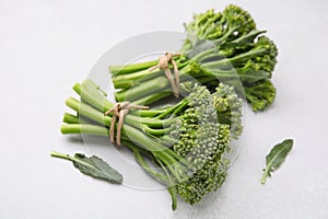 Fresh raw broccolini on white background, closeup. Healthy food