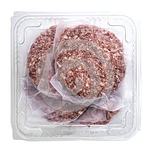 Fresh raw burger patty in a plastic box isolated on white