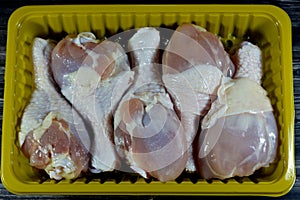 Fresh raw chicken legs drumsticks hindquarter with skin and bones that is ready for baking, grilling, barbecuing, frying or