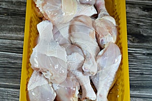 Fresh raw chicken legs drumsticks hindquarter with skin and bones that is ready for baking, grilling, barbecuing, frying or