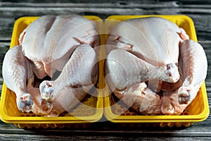 Fresh raw chicken with skin and bones, the whole chicken with breasts, legs, thighs, chicken meat that is ready for baking,