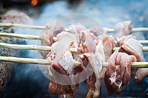 Fresh raw chiken meat on fire