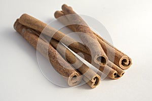 Fresh raw cinnamon sticks on white background