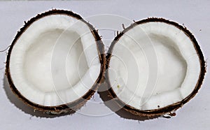 Fresh raw coconut in two pieces isolated on white background.
