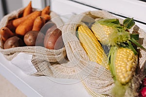 Fresh raw corn in eco canvas grocery bag. Cotton bags with vegetables. Zero waste shopping concept. Plastic free items