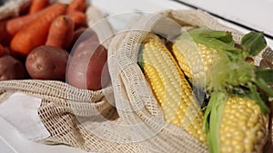 Fresh raw corn in eco canvas grocery bag. Cotton bags with vegetables. Zero waste shopping concept. Plastic free items