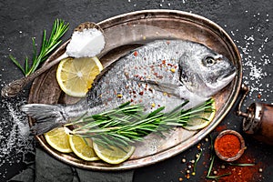 Fresh raw dorado fish with ingredients for cooking