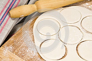 Fresh raw dough and rolling pin