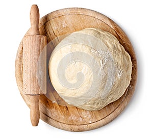 Fresh raw dough on wooden board