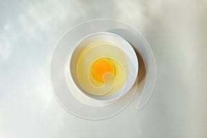 Fresh raw egg bowl on white background with Light and shadow from the window in the morning.