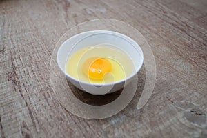 Fresh raw egg bowl on white background with Light and shadow from the window in the morning