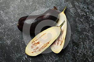 Fresh raw eggplants on black smokey background