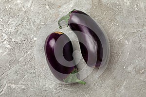 Fresh raw eggplants on gray background, close up