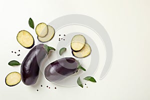 Fresh raw eggplants on white background, top view