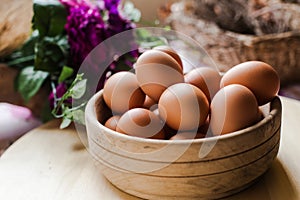 Fresh raw eggs inside wooden basket