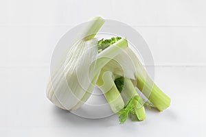 Fresh raw fennel bulbs on white table, closeup