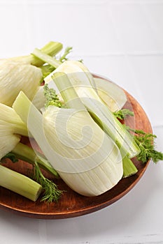 Fresh raw fennel bulbs on white table, closeup