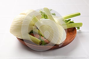 Fresh raw fennel bulbs on white table, closeup