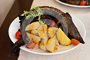 Fresh raw fish pike perch on foil for baking with vegetables, prepared for cooking, on a wooden background