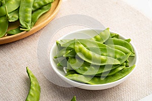 Fresh raw flat green peas or snow peas