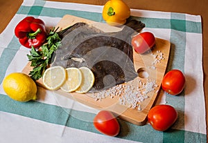 Fresh raw flounder on cutting board