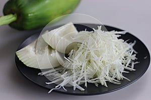 Fresh raw green papaya and shredded papaya on display, perfect for healthy recipes and vibrant salads